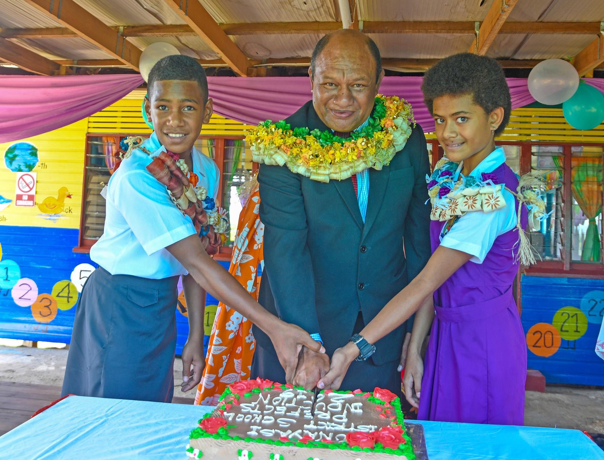 Minister for Forests, Hon. Osea Naiqamu cuts cake with student prefects of Vunayasi Primary School to mark the launch of activities leading up to International Day of Forests 2019.